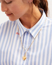 Danica Wearing a Striped Shirt and Our Paperclip Chain Necklace With Our Heart Locket Charm Attached To It