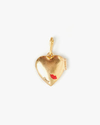 Back Of Our Hear Locket Which Has Clare V. Engraved in Very Small Letters on The Lower Corner and Red Lips Slightly Above It