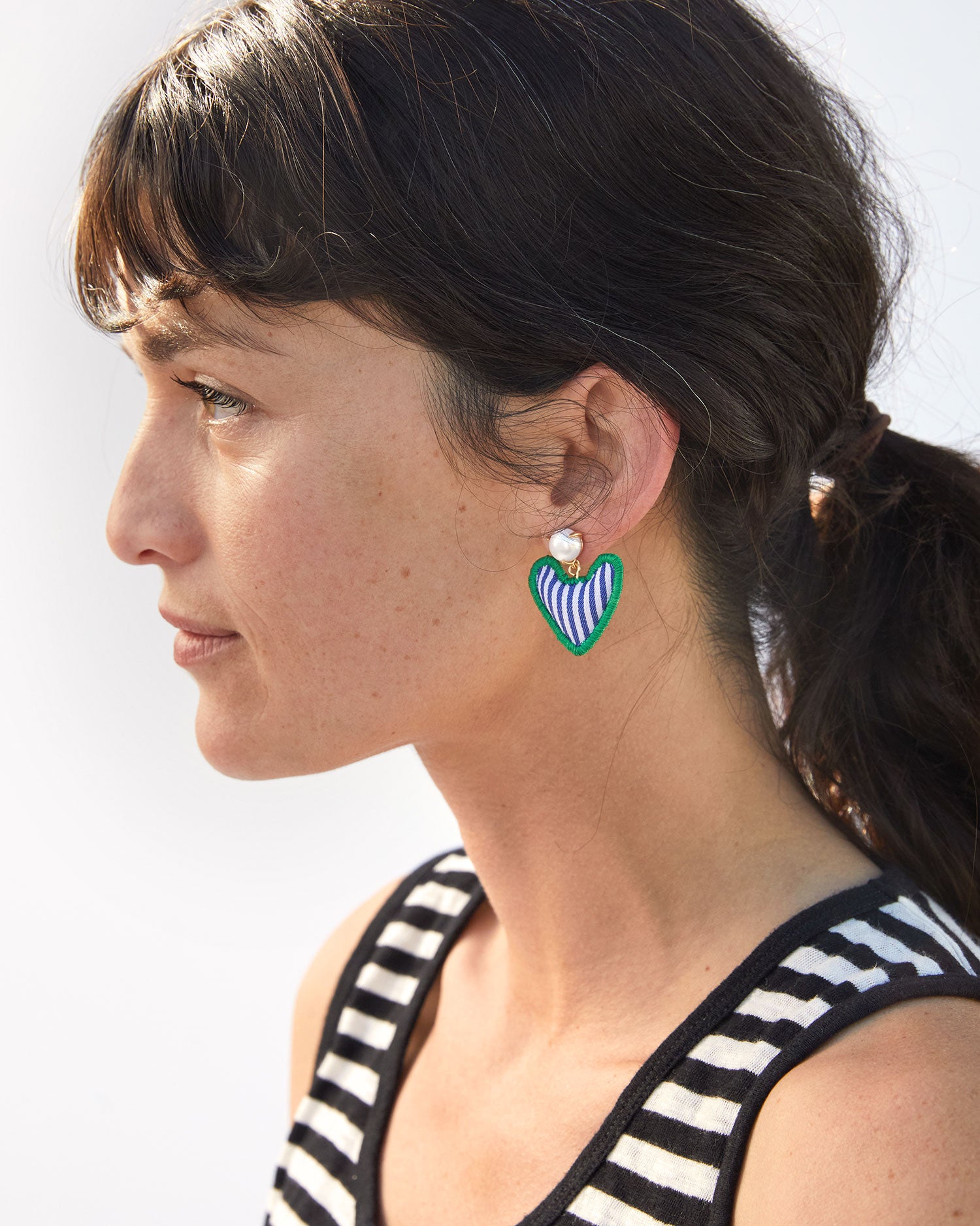 danica looking away from the camera wearing the Heart Pillow Statement Earrings