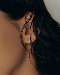 model wearing the kinn studio Pavé Hoop Huggie Earrings with only her ear in frame