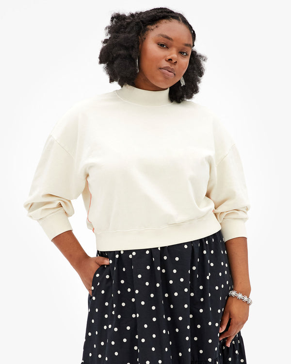 Candice wearing the Cream Le Drop Turtuleneck with the Black & White Polka Dot Manon Skirt.