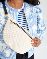 close up of the cream perf grande fanny worn across candice's chest with the Black Veg Grande Fanny Belt