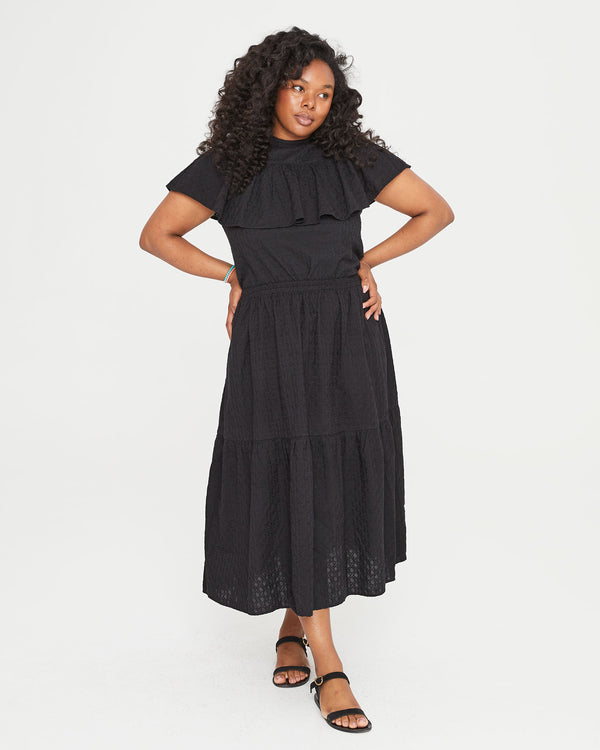 Candice wearing the Black Eyelet Rattan Manon Skirt with the black eyelet rattan maxine blouse tucked in 