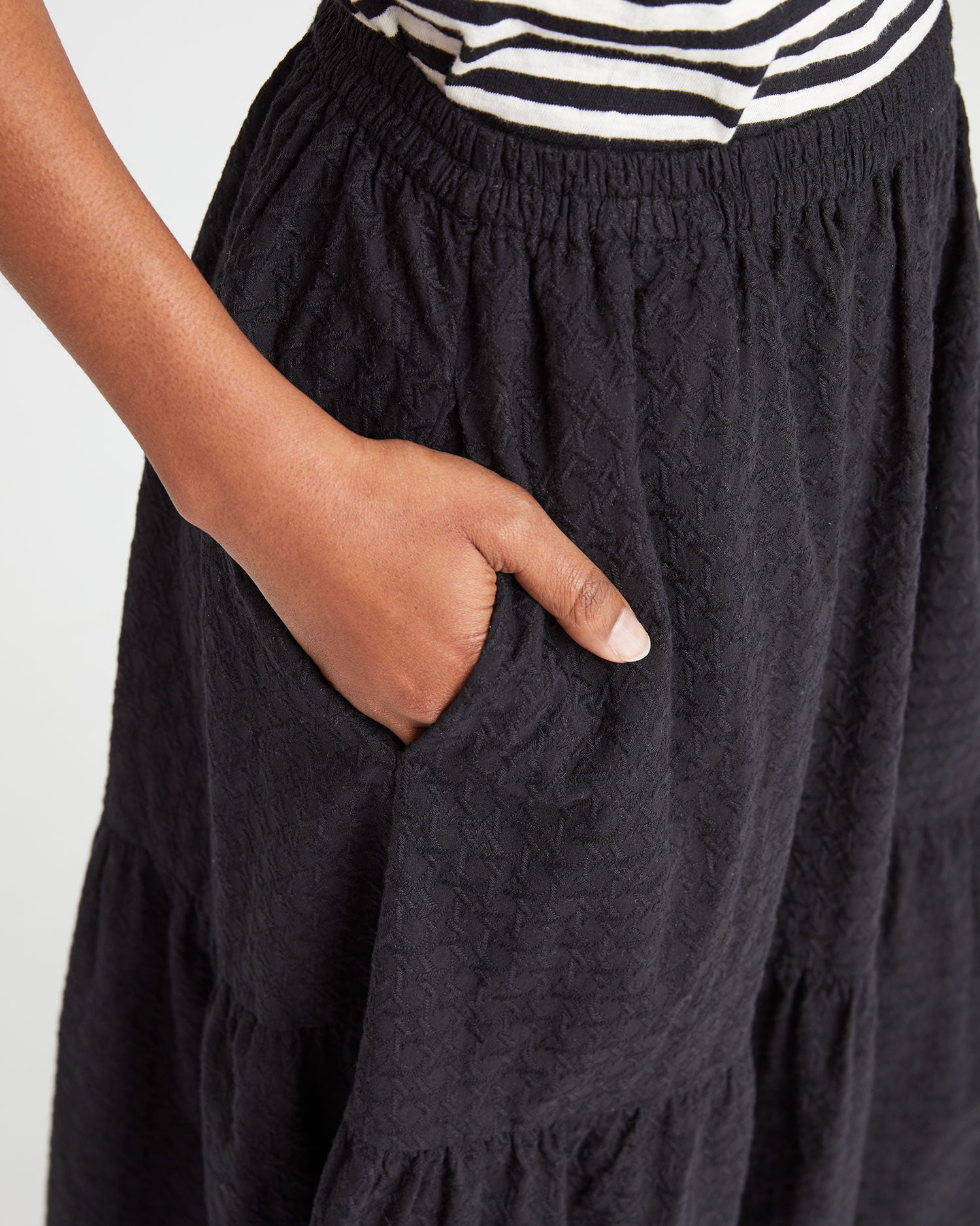 close up of Mecca's and in the pocket of the Black Eyelet Rattan Manon Skirt