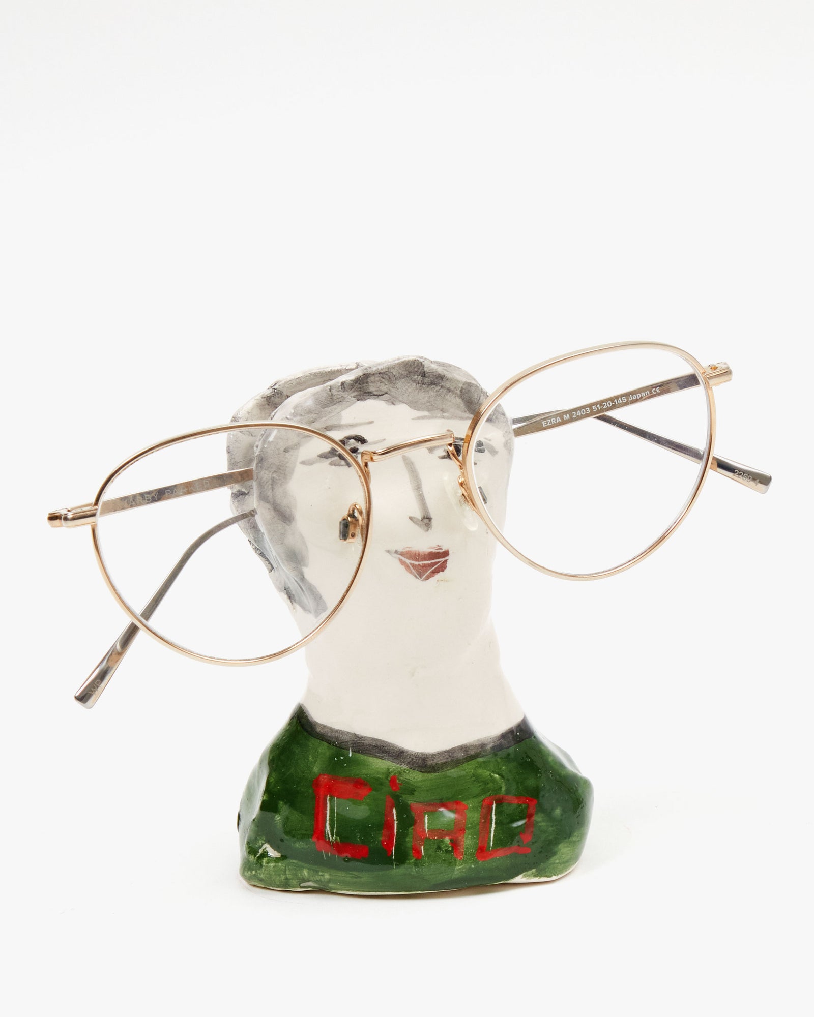 Marco Ferrini Ciao Male Spectacles Holder with a pair of wire frame glasses on them 