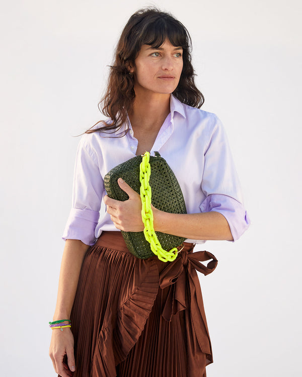 danica holding the army rattan marisol with the neon yellow resin shortie strap attached