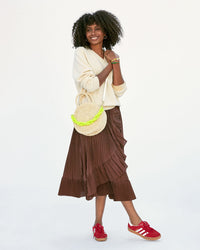 Mecca wearing the Cream Moyen Alice crossbody with the neon yellow resin shortie strap attached