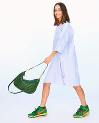 Frannie Wearing a Dress and Sneakers with the Evergreen Woven Zig-Zag Moyen Messengers by her Side