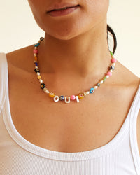 Andrea wearing the Oui Multi Flower Strand Necklace with a white tank top
