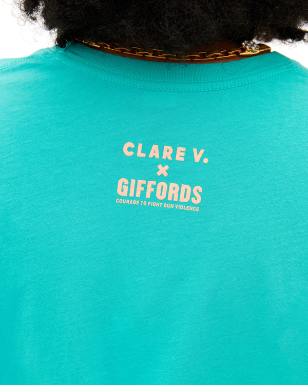 Close up of the back logo on the Desert Turquoise Espoir et Courage Original Tee, worn by Candace