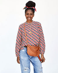 Mecca Wearing Jeans and the Red & Navy Checker St. Martin Top with the Natural Woven Checker Petit Moyen Worn Crossbody