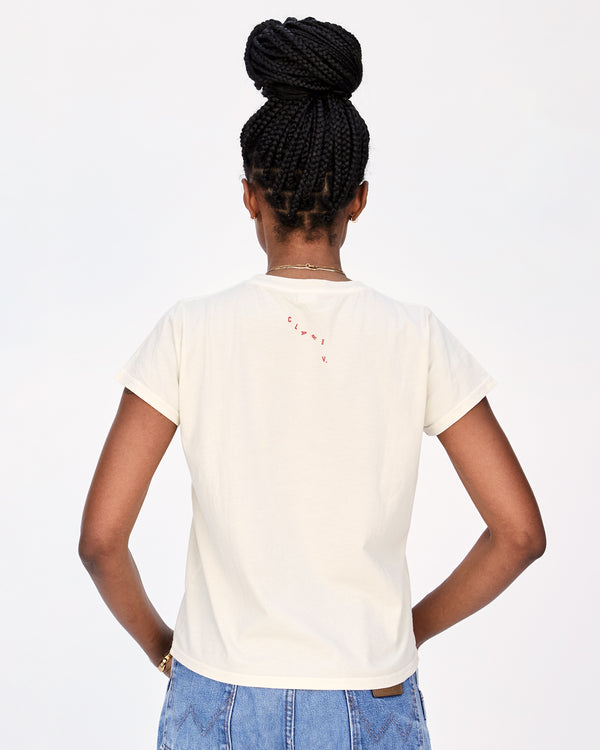 Back View of Mecca Wearing the Cream Apéro Classic Tee with Blue Jeans 