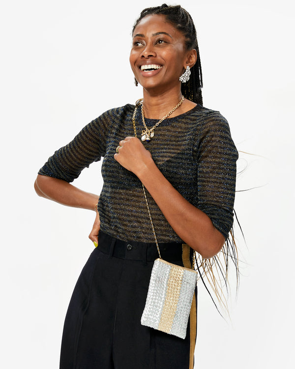 Mecca wearing a sparkly stop, a metallic poche and the Clear and Shiny Rhodium Finish Encrusted Statement Studs and other assorted CV jewelry 