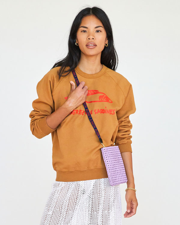 Navy with Poppy Allons-y Lanyard on the Lilac Rattan Poche, worn by Sandra