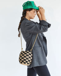 Miwa Fixing her Hat While Wearing the Black & Natural Checker Pot de Miel with the Thick Chain Crossbody Strap