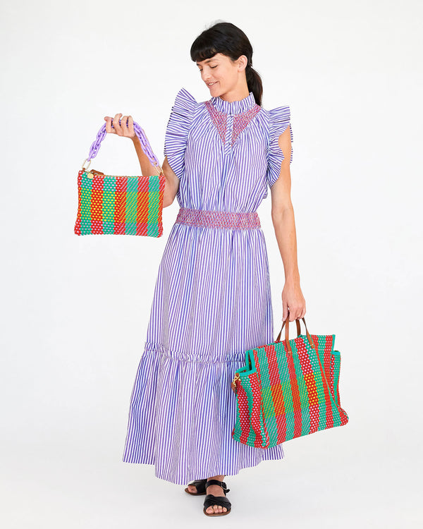 danica holding the multi plaid flat clutch with tabs by the dark Lilac resin shortie strap. she's wearing the joelle dress and has the multi plaid summer simple tote in her left hand
