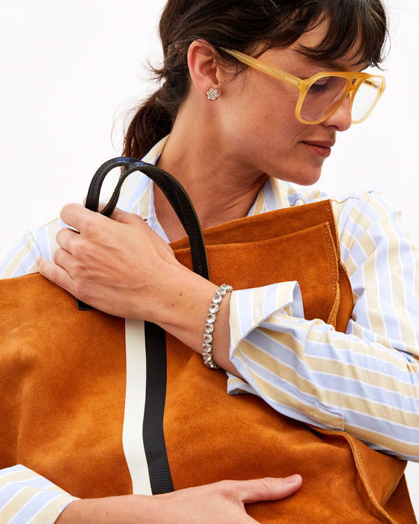Danica Holding Our Camel Suede with Black and White Stripes Simple Tote and Our Stone Tennis Bracelet in Clear on Her Left Wrist