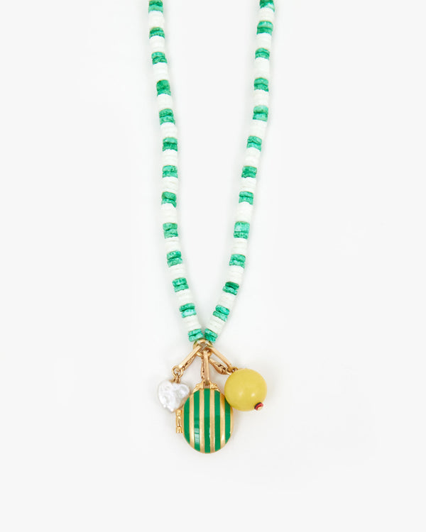 White & Emerald Stacked Shell Necklace Shown with the Freshwater Pearl Mini Heart Charm, the Stripe Locket Charm, and the Yellow Stone Bead Charm