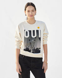 Aurelia wearing the Cream Oui Sweatshirt with  black jeans