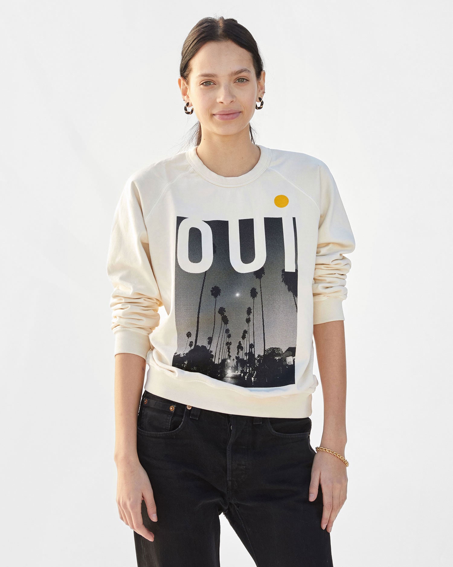 Aurelia wearing the Cream Oui Sweatshirt with  black jeans
