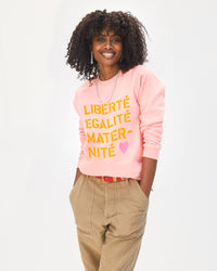 mecca wearing the rose every mother counts sweatshirt with khaki pants