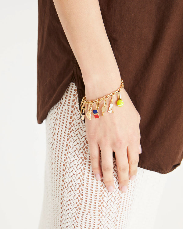 Athena wearing the Tennis Racquet Charm and assorted other Clare V. Charms on the charm chain bracelet