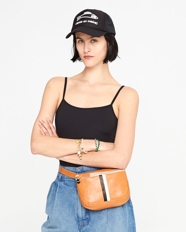 athena wearing the Black with Liberez les Sardines Trucker hat with the natural fanny pack