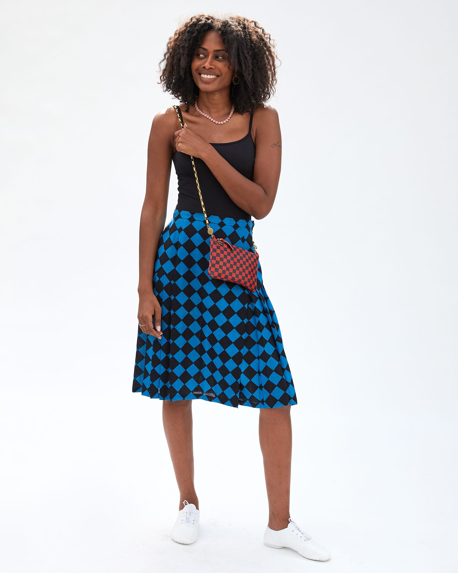 mecca carrying the Red and Navy Checker Wallet Clutch w/ Tabs  with the box chain crossbody strap