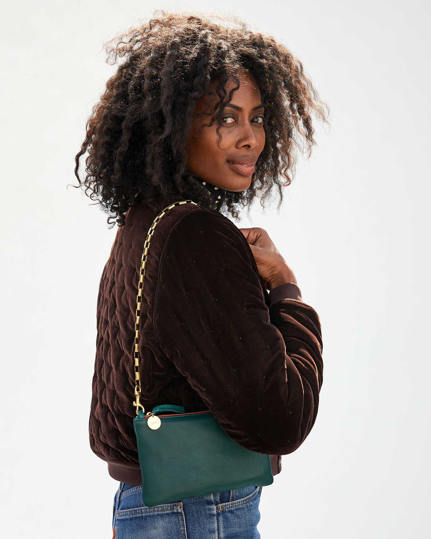 Mecca carrying the Deep Sea Wallet Clutch with Tabs by the Brass Box Chain Shoulder Strap
