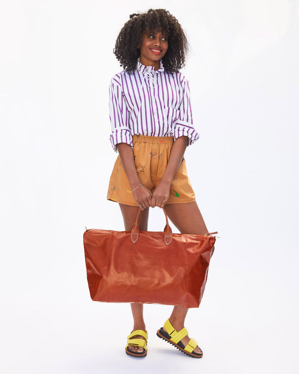 Mecca Holding the Camel Weekender by its Shoulder Strap