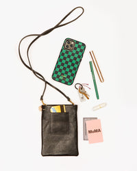 black poche with a selection items that fit inside