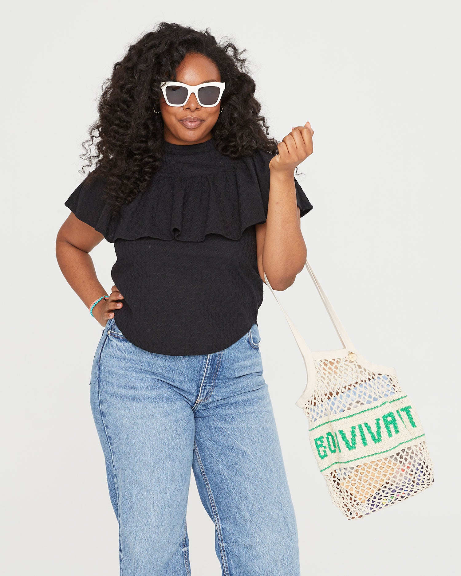 candice wearing the cream heather sunglasses, the black rattan maxine blouse with the Natural with Bon Vivant Woven Netty on the crook of her elbow