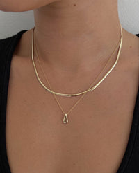 model wearing the Teardrop Necklace layered over a simple shiny chain necklace